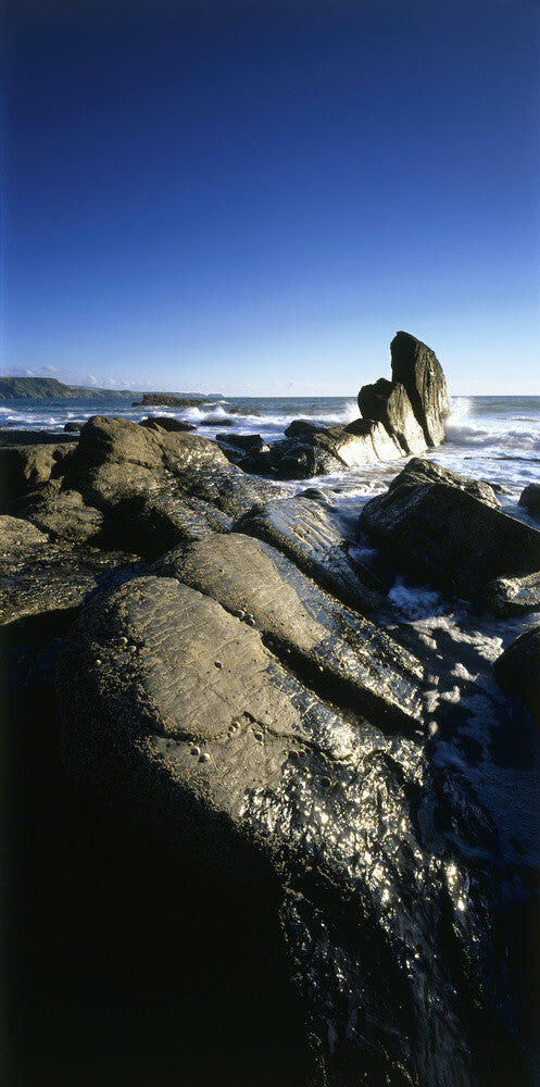 A close view of folded and eroded granite rock strata at Little Strand, Cornwall