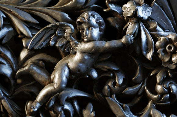 Carving of a cherub, part of the Charles Wade collection at Snowshill Manor, Gloucestershire