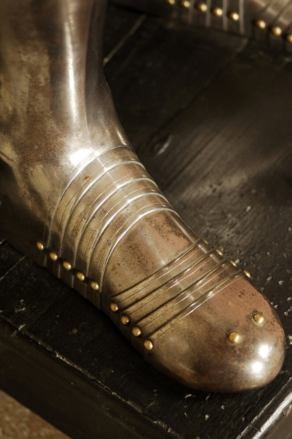 Close view of the foot of a suit of German armour at Snowshill Manor, in the room known as Dragon