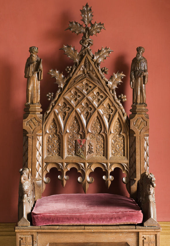 Neo-Gothick oak armchair carved by John Baldwin in 1863 and bearing Disraeli's coat of arms, in the Garden Hall at Hughenden Manor, High Wycombe, Buckinghamshire