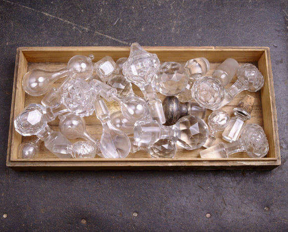 A tray full of glass stoppers, and one with silver, for decanters, in the Butlers Passage at Tyntesfield