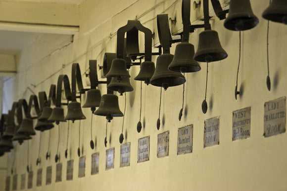 Long line of servants bells in the corridor next to the Still Room at Dunham Massey, Cheshire