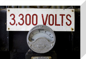 Close up of mining equipment - an electricty meter and volatge notice