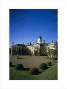 Polesden Lacey house, the beautiful east front with round topiary bushes in foreground