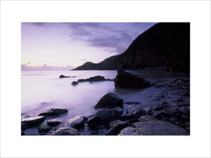 View of Woody Bay, North Devon with rocks in the foreground at dawn