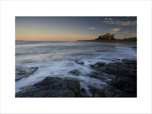 A long view at sunset of Bamburgh Castle on the far horizon (Not National Trust)