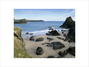 A view looking down into Kynance Cove on the Lizard Peninsula with unusual rocks formations on the sandy beach