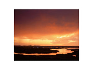 A spectacular glowing sunset over the tidal estuary at Blakeney Point