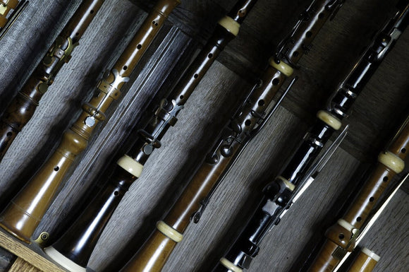 Close view of clarinets, flutes, piccolo and oboes, part of the musical instrument collection of Charles Paget Wade, in the Music Room at Snowshill Manor, Gloucestershire