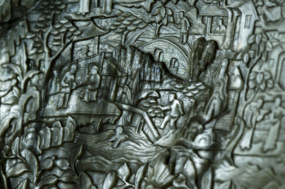 Close view of carved Chinese scenes, in Zenith, part of the Charles Wade collection at Snowshill Manor, Gloucestershire