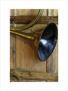 Close view of part of a tenor cor, part of the musical instrument collection in the Music Room at Snowshill Manor, Gloucestershire