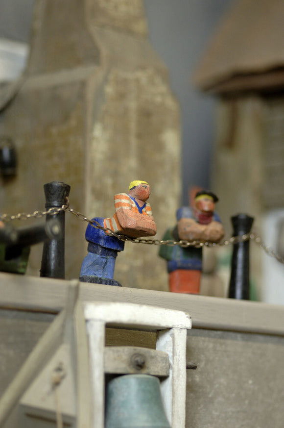 Close view of two wooden figures, part of the reconstruction of Wolf's Cove, the model village which was once in the garden at Snowshill Manor but is now in the room known as Occidens
