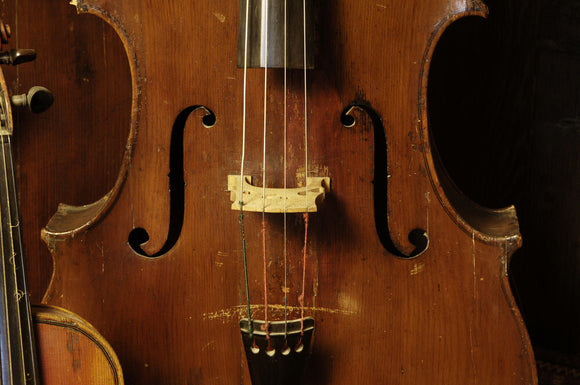 A double bass, part of the musical instrument collection of Charles Paget Wade in the Music Room at Snowshill Manor, Gloucestershire