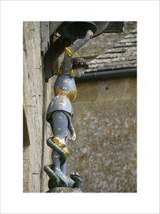 Close view of the teak statue of St George, mounted on the wall of Wade's cottage in the garden at Snowshill Manor, Gloucestershire, UK