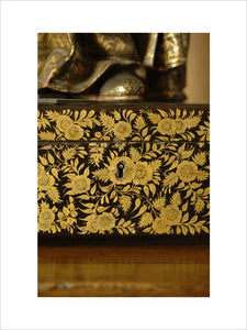 Close view of the gold flower and foliage decoration in Chinese style on a black and gold lacquer box in Nadir at Snowshill Manor, home of collector Charles Wade