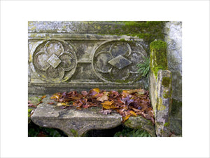 Close view of a stone bench outisde the Gothic Cottage at Stourhead, Wiltshire, in the autumn