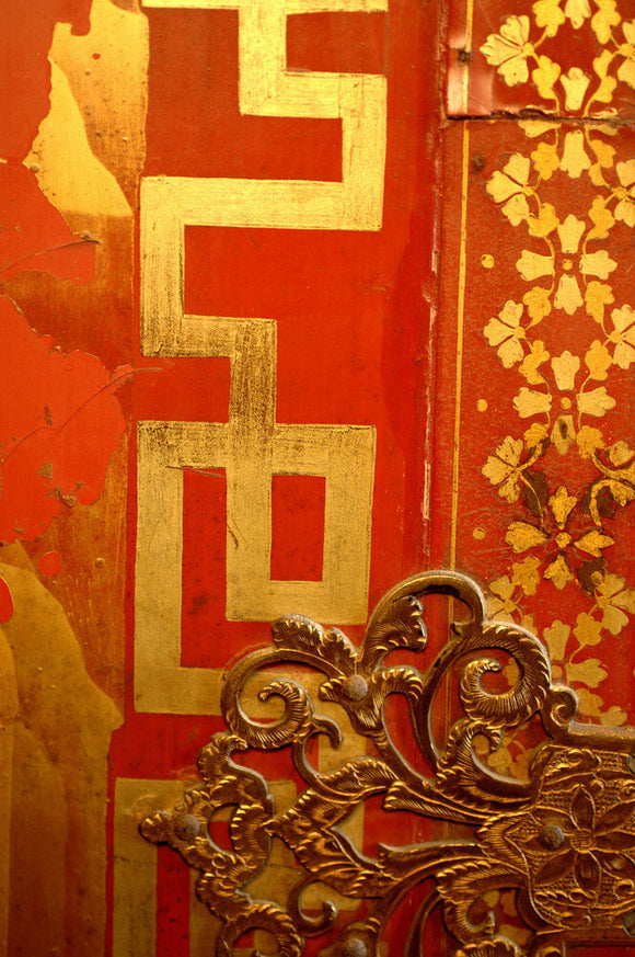 Close view of the detail of a French, red lacquered cabinet in the Grey Room at Snowshill Manor