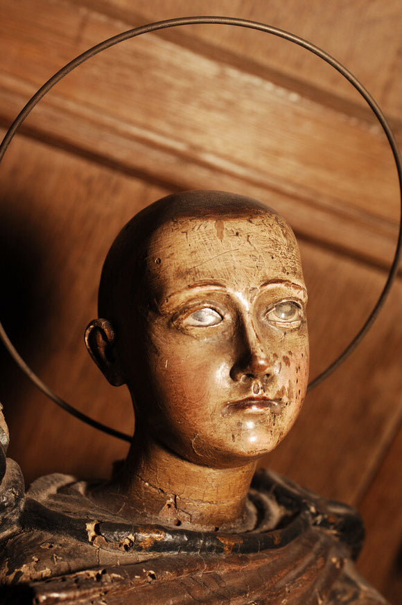 A carved wooden figure of a Saint, in the room called Nadir, at Snowshill manor, home of the collector Charles Wade in Gloucestershire