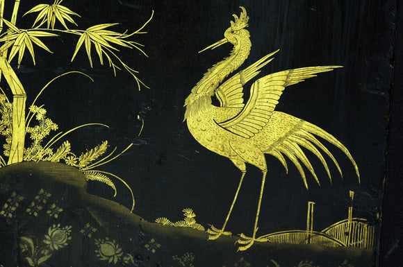 Close view of the gold decoration on the Chinese shrine cabinet in Zenith, part of the Charles Wade collection at Snowshill Manor, Gloucestershire