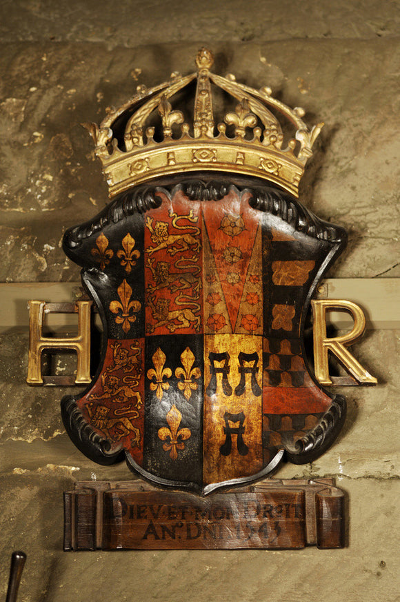 Coloured shield of the royal coat of arms of Henry VIII on the wall of Dragon, at Snowshill Manor