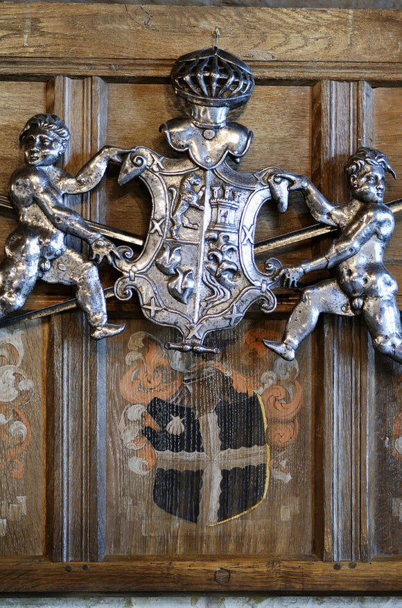 Carved Coat of arms Hang Above A Painted Coat of arms On The Wooden Pa carved-coat-of-arms-hang-above-a-painted-coat-of-arms-on-the-wooden-pa