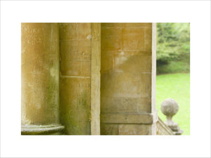 A close view of the C18th columns of the Palladian Bridge at Prior Park, Bath, UK, showing grafitti