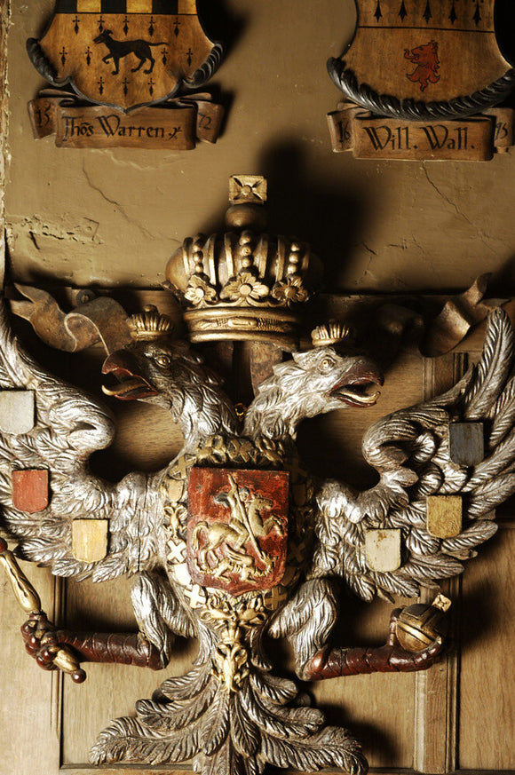 Carved wooden Russian imperial coat of arms on the wall of Dragon at Snowshill Manor, Gloucestershire