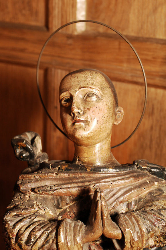 A carved wooden figure of a Saint, in the room called Nadir, at Snowshill manor, home of the collector Charles Wade in Gloucestershire