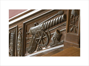 Close view of part of the panelling of the Great Staircase at Ham House, Surrey with the balustrade carved with trophies of war