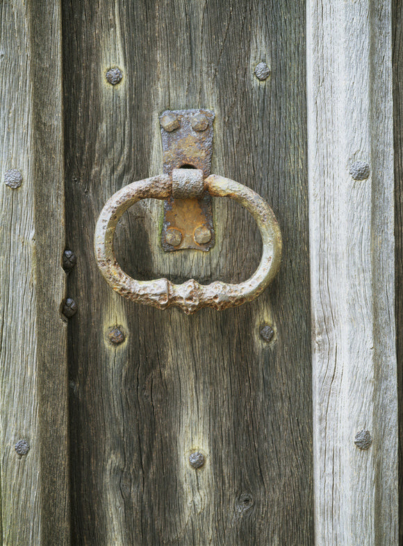 Detail of a rusting door handle at Nymans Garden, taken on November, on a wooden door