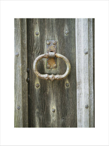 Detail of a rusting door handle at Nymans Garden, taken on November, on a wooden door