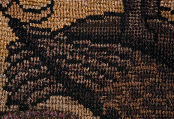 The hind quarters and tail of a bird from a motif on the Marian Needlework at Oxburgh Hall