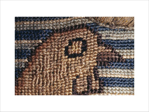 The head of a bird against a blue & white striped background as part of a motif from the Marian Needlework at Oxburgh Hall