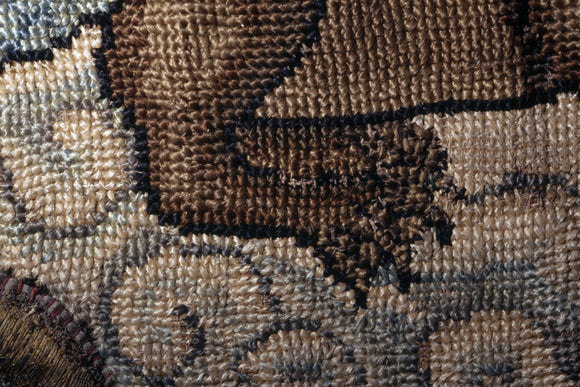 The back legs and part of the hind quarters of a creature from a motif on the Marian Needlework at Oxburgh Hall