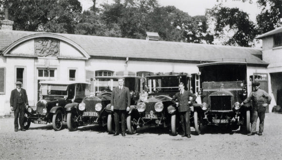 Chauffeurs and mechanics with Mrs Greville's fleet of cars in the stables at Polesden Lacey