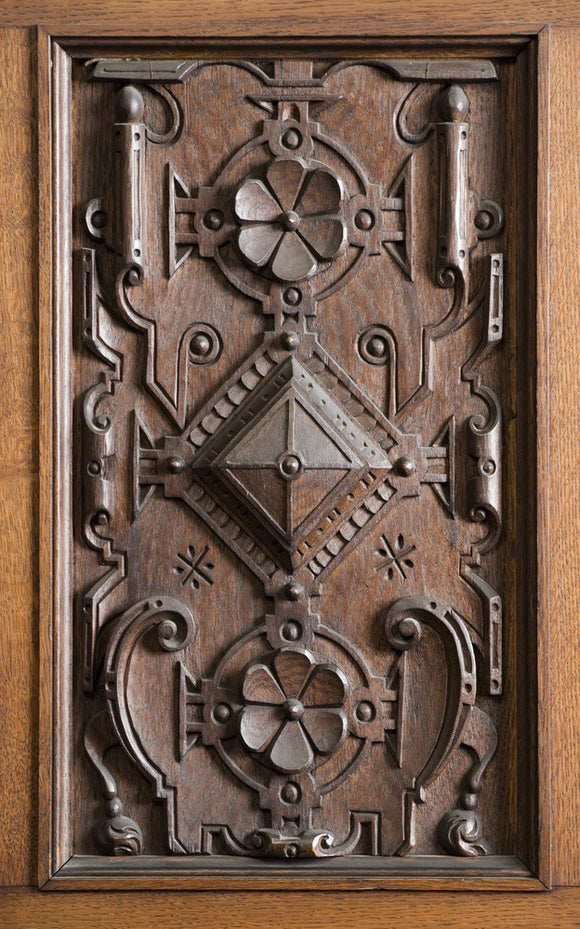Close view of part of the wooden carving on the door panels of the Library in the new house at Scotney Castle, Kent
