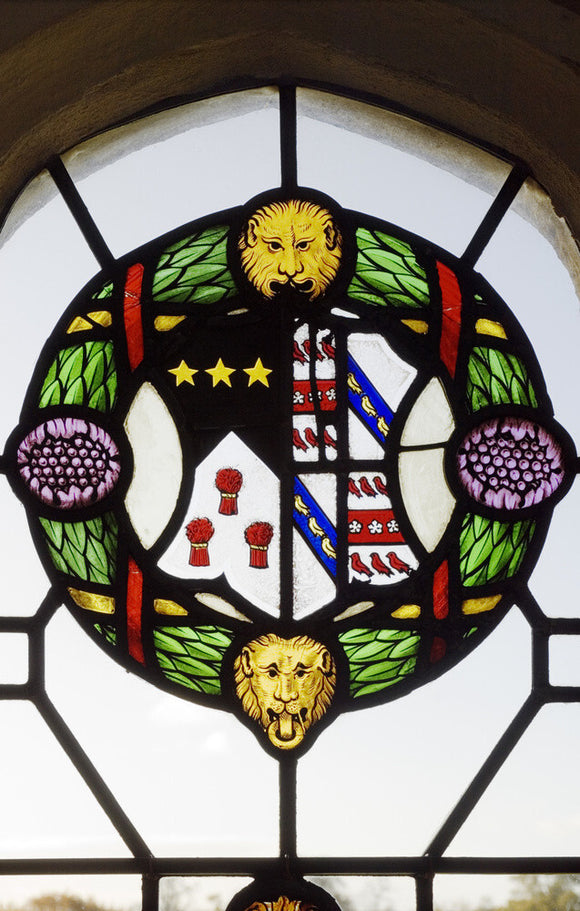 Detail of the lattice-paned windows with roundels and shields of heraldic glass commemorating the marriages of the Throckmorton family with other Catholic families, in the Drawing Room at Coughton Court, Warwickshire