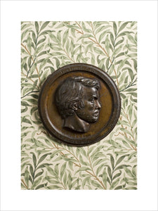 Bronze bas-relief plaque of Thomas Carlyle by Thomas Woolner, 1855, against the William Morris wallpaper "Willow Bough" in the Drawing Room at Carlyle's House, 24 Cheyne Row, London