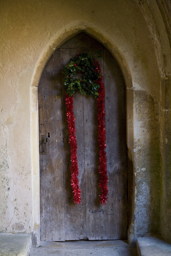Christmas decorations on the wooden door at the Christmas fair at Lacock Abbey, near Chippenham, Wiltshire