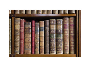 Leather bound books on the shelves in the Library at Hughenden Manor, Buckinghamshire, home of prime minister Benjamin Disraeli between 1848 and 1881