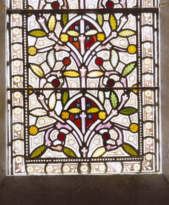 Close up of floral design in a stained glass window at the Chapel at Tyntesfield