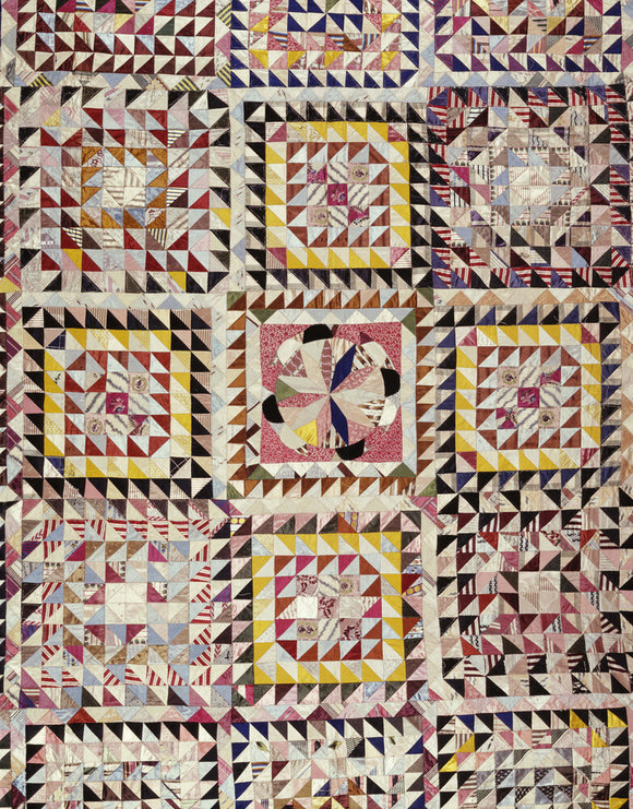 Close view of patchwork quilt from the bedroom in the Quantoxhead Suite at Dunster Castle showing nine sections of the work