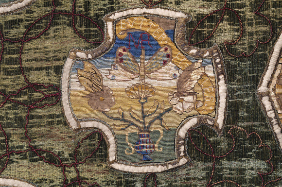 A motif of butterflies and flowers, and the initials MR from the Marian Needlework at Oxburgh Hall