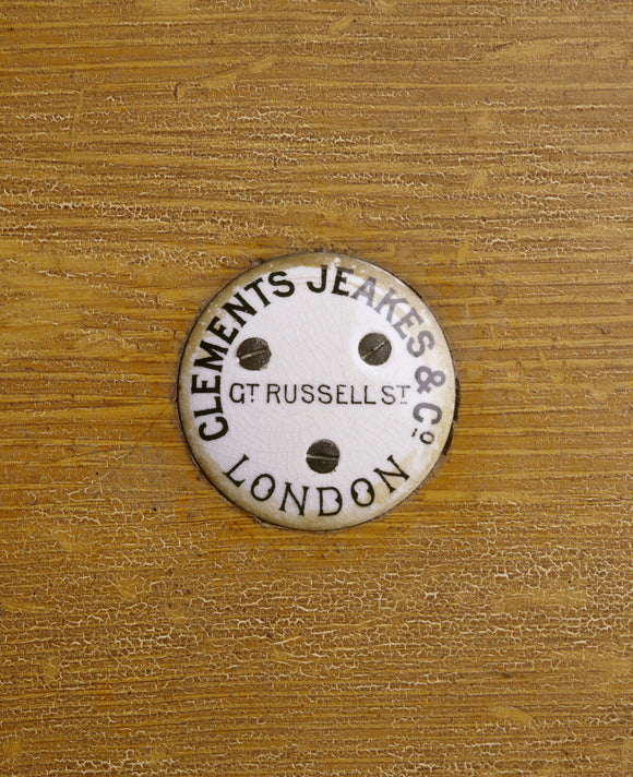 Close view of a ceramic plaque with the name and adress of the contractor for the kitchen fittings provided for the mordenisation of Dunham Massey in 1906