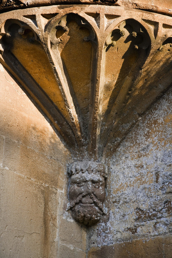 Mask corbel at the base of the tracery of the East oriel window at the fifteenth-century Great Chalfield Manor, Wiltshire