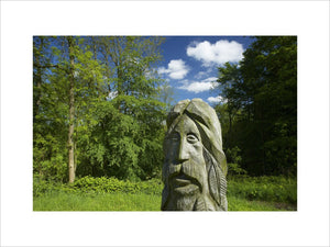 Carved wooden figure amongst the woodland at Ebworth near Painswick, Stroud, Gloucestershire