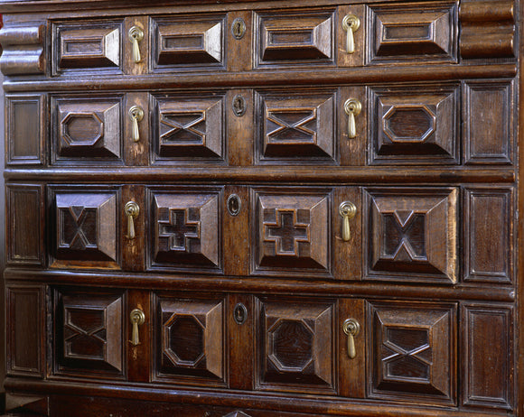 Close view of the carved wooden chest in the North Bedroom at Great Chalfield Manor, near Melksham, Wiltshire