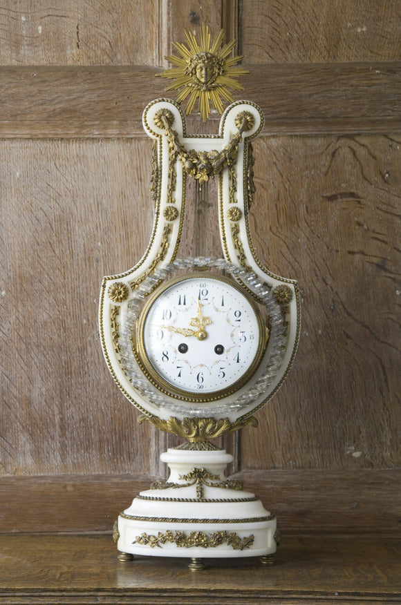 An early nineteenth-century French lyre clock with a diamante pendulum in the Library at Baddesley Clinton, West Midlands