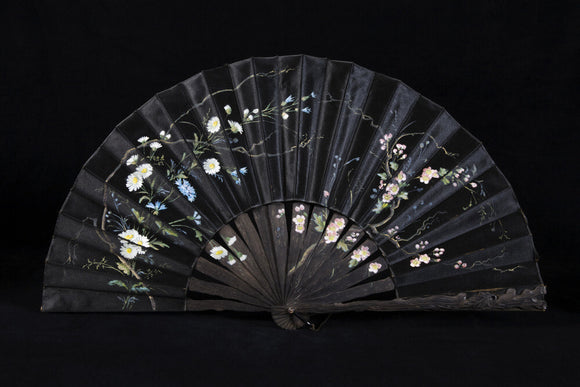 A fan in the display cabinet of objects collected by Miss Chichester in the Upstairs Corridor at Arlington Court, Devon