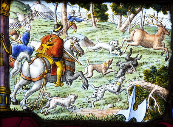 A sixteenth or seventeenth century Swiss-German stained glass panel with a deer hunting scene in the Hall at Upton House, Warwickshire